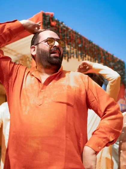 A candid shot of a guest enjoying the music and dancing at the Haldi. These photos of friends and family add to the rich tapestry of the wedding day.