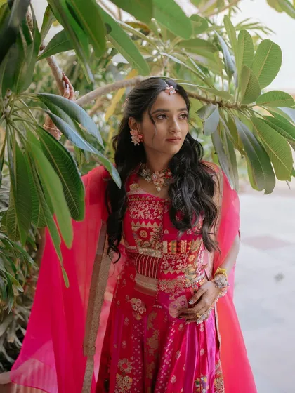 A portrait of the Haldi bride, with her softly waved hair and delicate floral jewellery creating a fresh and youthful appearance.