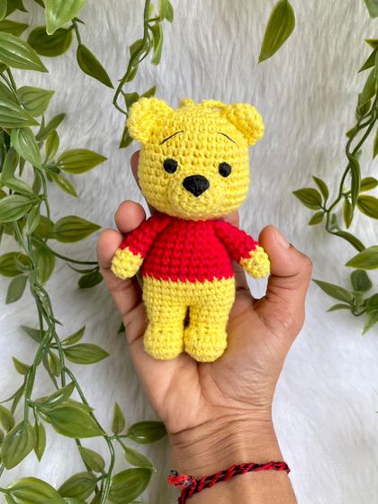 A sweet Winnie the Pooh keychain. This classic character is perfect as a small, adorable accessory to hang on a bag or keys, bringing a little bit of the Hundred Acre Wood with you.