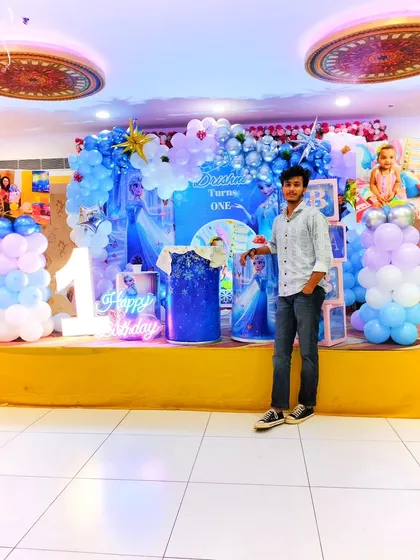 Meet the person behind the magic! This is me, the owner, standing proudly next to one of my birthday creations. I put my heart into every single event to make it special for you.