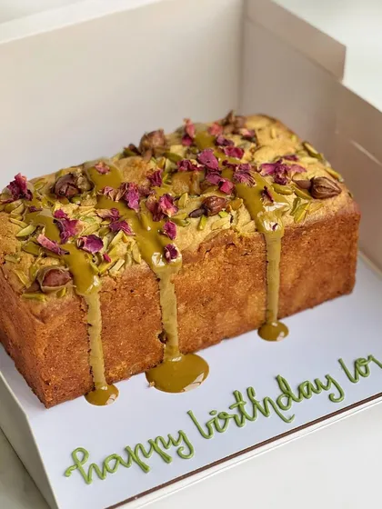 My honey pistachio and rose & orange almond tea cakes are perfect for an evening snack. This pistachio loaf cake is drizzled with a pistachio glaze and garnished with nuts and rose petals.