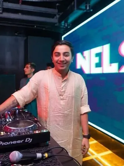 Standing at my console with custom "Nelson" visuals on the big screen. I make sure my brand and energy are a core part of your event's aesthetic.