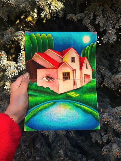 Holding the 'Houses of Illinois' sketchbook drawing outdoors, showing the piece in a natural light.