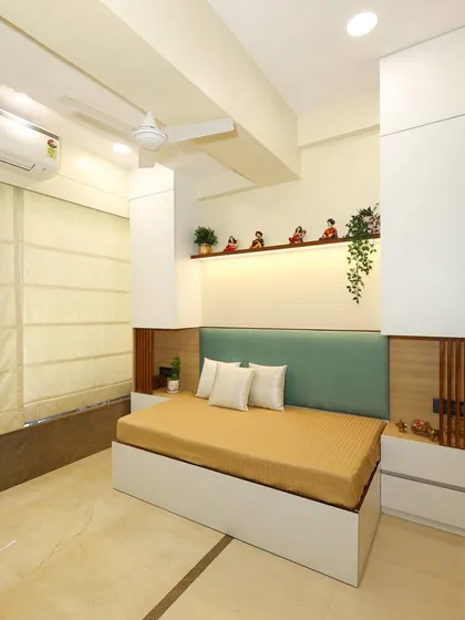 We converted a lounge space into this simple yet spacious-feeling bedroom for parents, using white with splashes of green, beige, and natural wood.