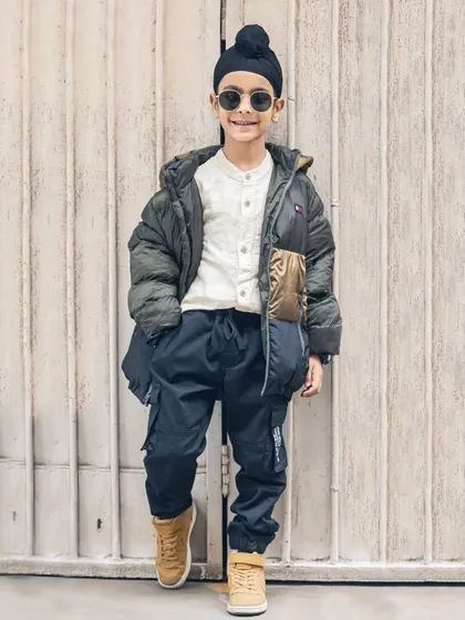 A full-length shot of this stylish young boy during his outdoor photoshoot. He looks like a professional model!