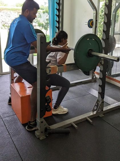 A female athlete performs a squat assessment. We ensure that all our players, regardless of gender, are building a strong and stable lower body to power their swing and prevent injury.