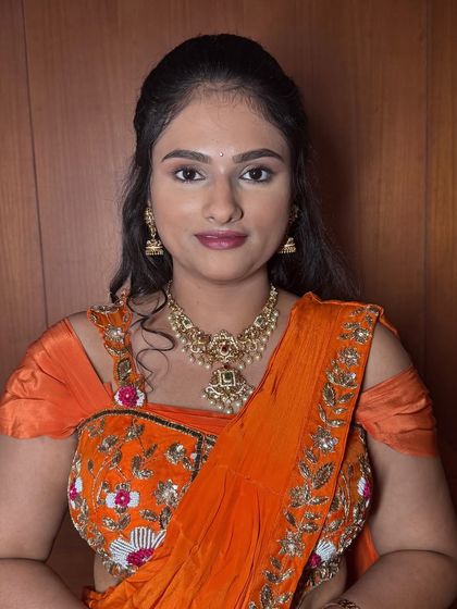 A classic portrait of Rekha. Her makeup is a perfect example of soft glam, with neutral tones on the eyes and a natural lip color suitable for any event.