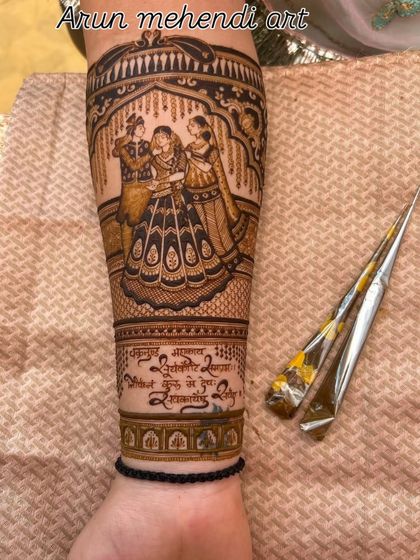 A close-up of a forearm with a family portrait and a special verse written in Hindi.