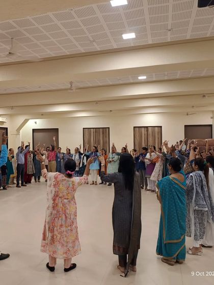 Teachers standing in a circle, participating in a group activity during a workshop. I use these collaborative exercises to build a sense of community and demonstrate the power of connection in a classroom setting.