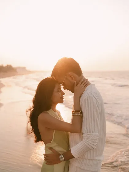 Bathed in the golden hour light of a Muscat sunset, this is a moment of pure connection. An intimate embrace on the beach, with the soft glow of the sun creating a warm, timeless silhouette. This is the quiet, powerful intimacy I seek in every pre-wedding portrait.