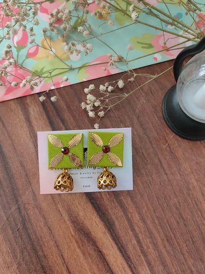 My gotapatti earrings are a festive favorite. These square fabric studs feature golden gotapatti work and a small jhumki drop, available in brown, green, and grey.