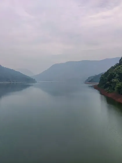The calm, expansive waters of the Kali river reservoir, surrounded by the dense forests of the Western Ghats. This is the serene backdrop for our Dandeli cycling adventure.