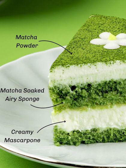 A cross-section of the Matchamisu, showing the layers of matcha-soaked airy sponge and creamy mascarpone, all topped with a dusting of fine matcha powder.