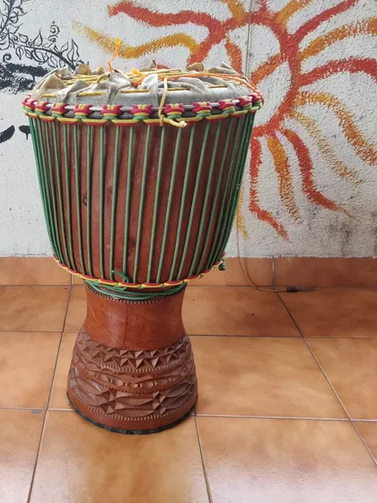 A look at a fully finished, custom-built djembe. Notice the intricate rope work for tuning and the hand-carved details on the wooden shell. Each drum is a unique piece, built to be an extension of your own voice.