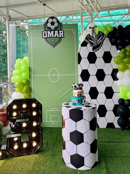 A goal-worthy celebration for Omar's 13th birthday. We designed this football-themed party with a soccer field backdrop, a hexagon-patterned wall, and large light-up numbers.