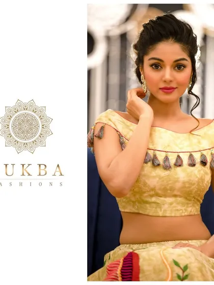 A close-up of the boat-neck blouse with its unique tassel detailing, part of a modern lehenga set perfect for festive occasions.