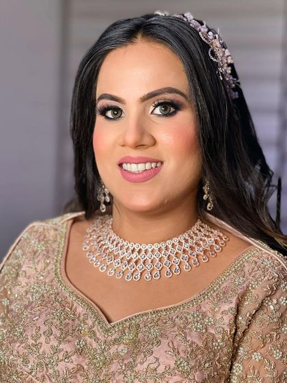 Aashi's engagement portrait. The look features dramatic smokey eyes, a flawless base, and a soft pink lip, paired with diamond jewellery.