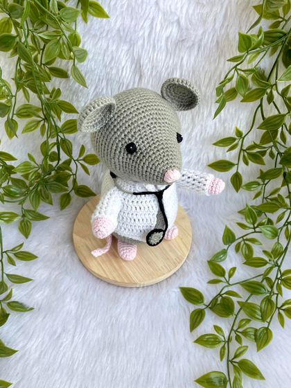 Dr. Mouse! This was a custom order for a graduation gift. The mouse is dressed in a doctor's apron with a tiny stethoscope and comes on a wooden base to be a display piece.