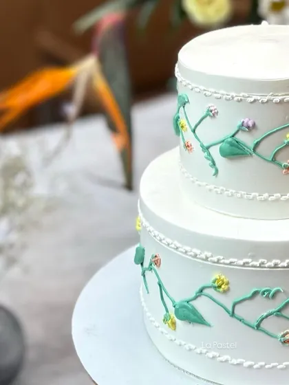 A detail shot of the hand-piped floral vines on this two-tier anniversary cake.