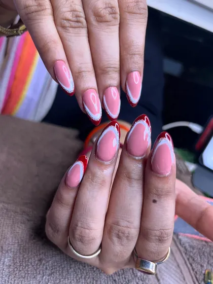 Another angle of the modern red and white French manicure, showcasing the consistency across all nails.