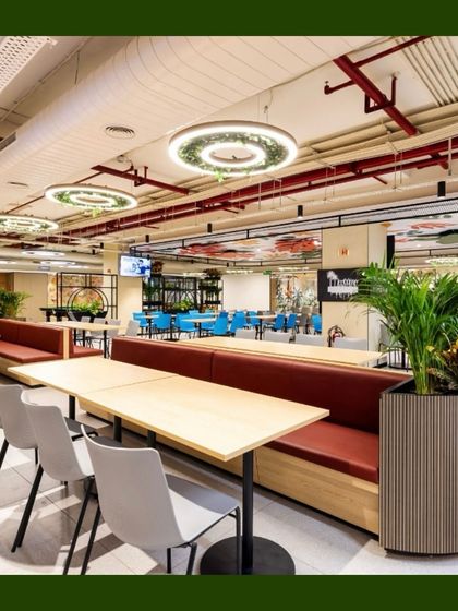 In this dining area, we used large, stylish planters to house tall palms and other foliage. These act as natural dividers between seating sections and add a touch of sophistication to the space.