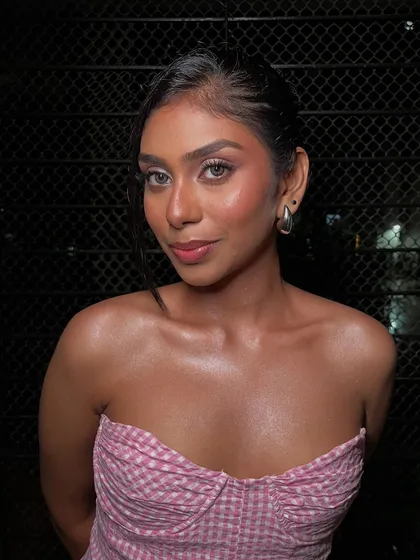 Feeling pretty in pink. This soft, angelic look on her rich skin tone features a rosy blush and glossy lips. The skin is the star, with a healthy, dewy glow that looks completely natural and unfiltered.