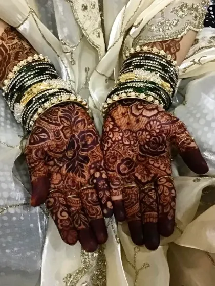 The final stain is everything. This photo shows the rich, reddish-brown color my natural henna develops into after a couple of days, beautifully complemented by the bride's traditional bangles.