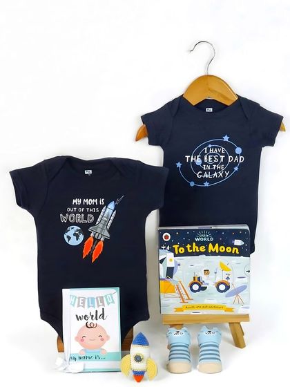 Another space-themed set, this time featuring two different onesies and a 'To the Moon' book. This shows how to bundle items for a larger gift.