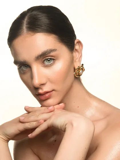 A beautiful example of a clean, luminous makeup look. I used highlighting techniques to catch the light on the high points of the face, creating a radiant glow that looks stunning on camera.