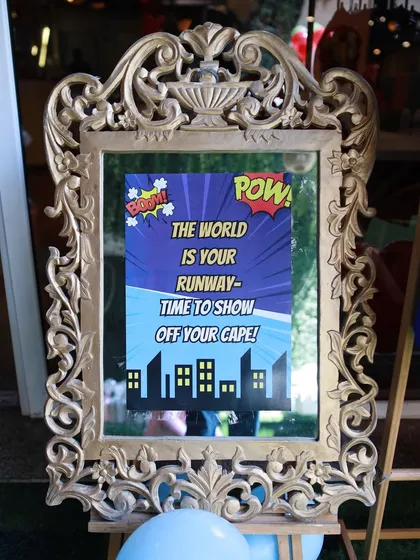 It's all in the details. We use themed signage, like this fun superhero runway sign, to enhance the atmosphere and encourage imaginative play.