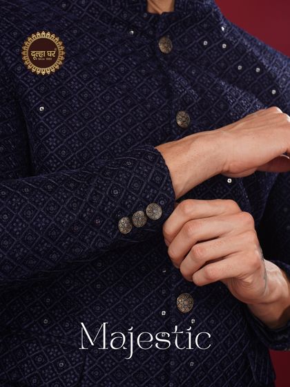 Majestic in every detail. A close-up of the navy blue textured jacket, showing the fine craftsmanship of the buttons and cuffs.