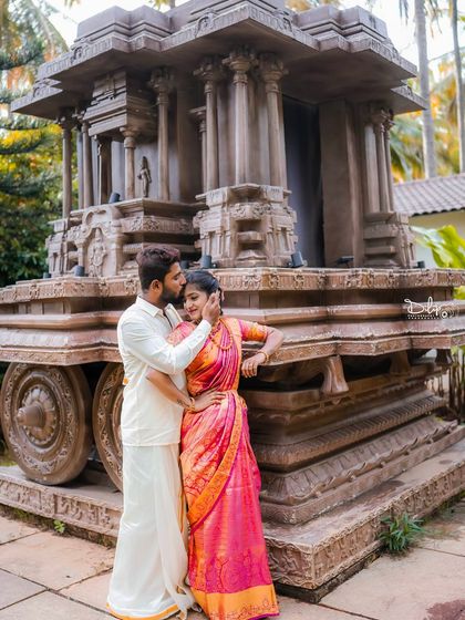 An intimate moment by the stone chariot, a perfect blend of love and heritage.