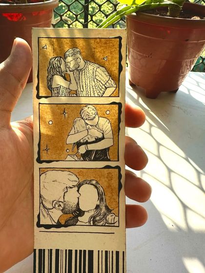 Another look at a completed photo strip, held up to catch the light. You can see the texture of the paper and the variations in the coffee stain, making each one unique.