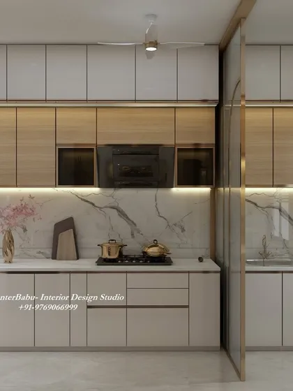 This kitchen uses a combination of wood-finish and white cabinets, creating a warm and modern aesthetic. The marble backsplash and under-cabinet lighting add a touch of sophistication.