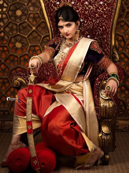 A full view of Sreeleela in her warrior attire, seated with authority. This image is all about creating a strong, iconic look for editorial features.