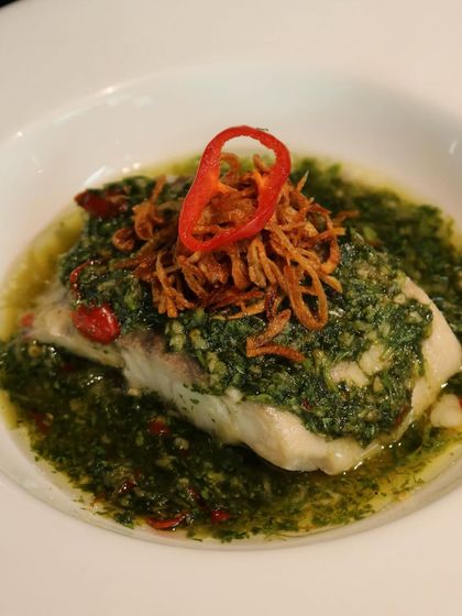 Steamed Chonak, a beloved Goan fish, flown in specially for the Grumps pop-up and served with a vibrant green chili sauce and fried onions.