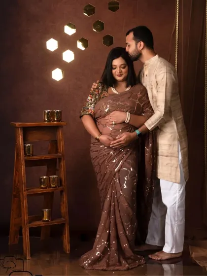 A sweet kiss on the forehead. This loving gesture is beautifully captured against the warm, glowing backdrop of the Shining Diva setup.