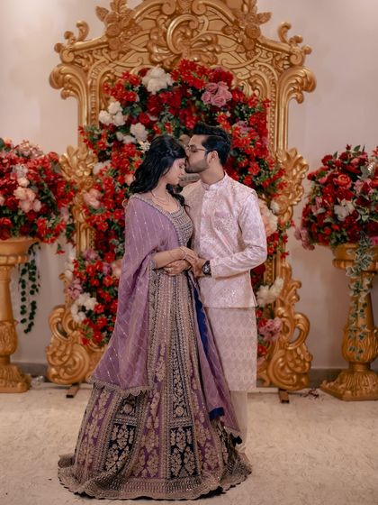 A tender kiss on the forehead, a promise of love and protection. This is a beautiful, emotional moment from their engagement photoshoot.