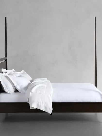 A side profile of the Brooklyn bed, showing the elegant tapering of the solid ash wood posts.