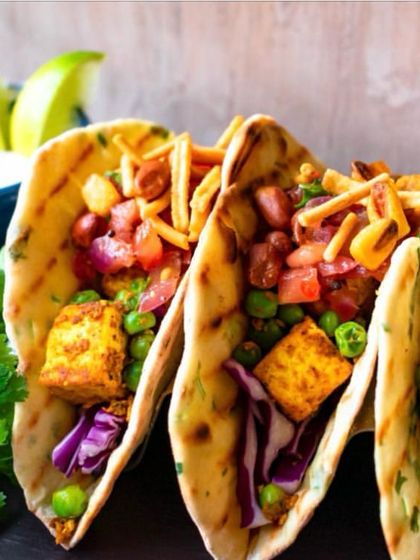 Our fusion tacos are always a party hit. Here, we've filled soft naan-style bread with paneer tikka and fresh salad, creating a delightful Indian-Mexican crossover dish.