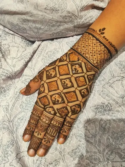 This back-hand design features a grid of tiny, repeating elephant motifs. It's a unique take on traditional patterns, creating a look that is both intricate and playful.