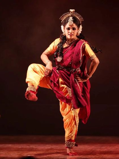 A solo performer captured in a moment of intense expression during "Shrishti Stithi Laya". The dramatic lighting and powerful posture convey the raw emotion of the story.