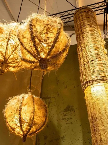 Woven light fixtures from the 'Edge of the Forest' installation. These pieces are made from natural fibers and traditional weaving techniques, casting a warm, dappled light.