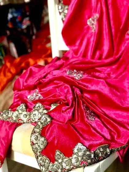 A luxurious fuchsia velvet saree with hand-embroidered borders and bootas. The lycra velvet drapes beautifully for a slimming effect, making it a rich and glamorous must-have for the winter wedding season.