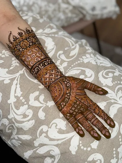 The complete hand and forearm design, showing how all the elements come together. This is a great example of a classic engagement henna look.