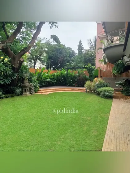 A wide expanse of pristine lawn provides a calm, open space that balances the complexity of the surrounding planting beds. This is the perfect area for children to play or for hosting a garden party.