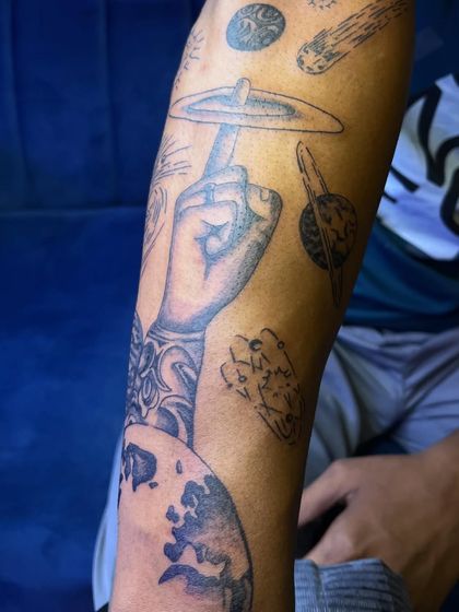Another view of the cosmic sleeve, showing how different shaded and line-work elements like Saturn and Earth come together to form a cohesive piece.