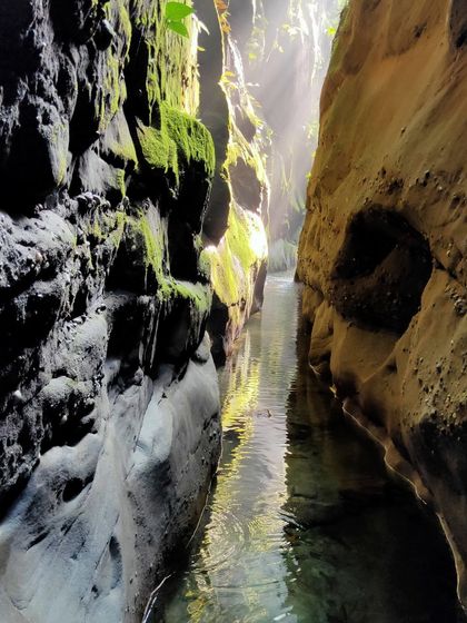 Sunbeams pierce the darkness of a deep slot canyon. These moments of beauty are the reward for pushing into these hidden worlds.