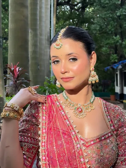 A classic portrait pose, showcasing the entire makeup and jewelry look.