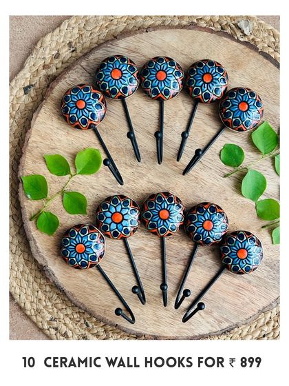 Introducing our new mini ceramic wall hooks. This image shows a set of 10 hand-painted hooks in a vibrant blue and orange design, perfect for adding a pop of color and functionality to your space.